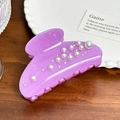 Elegant purple pearl hair claw clip with rhinestones displayed on a wooden surface - 8.6cm / Purple