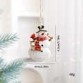 Christmas snowman resin ornament with black hat and red scarf hanging on a pine tree branch - Snowman with Red Scarf