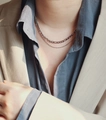 Close-up of double layer silver Figaro and cable chain necklace on a model - Silver
