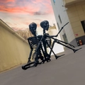 Detailed view of two posable black plastic skeleton figures for Halloween decorations - Black 90cm Skeleton