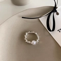 Detail view of a pearl and silver bead ring on a ceramic plate with elegant ribbons - Silver Square Bead Ring With White Pearl (J4064)