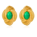 Close-up of vintage gold earrings with oval green stone and spiral texture - Green