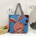 Blue tote bag with cartoon rabbit print and black-and-white striped woven handles - Style 1 - Cartoon Rabbit with Hearts (Blue)