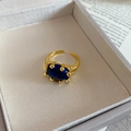 Detailed macro view of an oval lapis lazuli ring set in a gold plated adjustable band - Oval Open Ring / Lapis Lazuli Blue/Real Gold Plated
