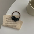 Detail of a brown elastic hair tie featuring a black handmade acetate chain decoration - Black
