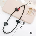 Zwarte kralen telefoon polsband met hartjes naast een roze hoesje 180mm 8g - Zwart Hart (K1057)