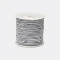 Detailed view of 1.2mm gray braided cord wound on a white spool for jewelry making - Color 484 Grey