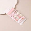 Detail showing pink and cream hair clip set with pearls, hearts and gold lettering - B Style-Pink Collection