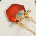 Vintage evil eye pendant necklace with red hexagonal crystal and gold plated finish - Watermelon red