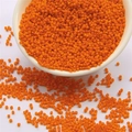 Vibrant orange 2mm glass seed beads for DIY jewelry making displayed in a white bowl - Orange Red