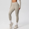 Close-up of high-waisted seamless yoga pants with a matte brushed finish for women - Camel Brown