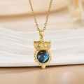 Elegant owl pendant necklace with blue cat eye stone on a delicate golden link chain - Gold Owl/Round Blue Star Stone
