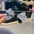 Detalle de una diadema con lazo de cristales brillantes y piedras de circonita - Clip de Pico de Pato con Lazo / Negro