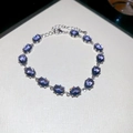 Elegant silver bracelet featuring oval-cut purple zircons and adjustable lobster clasp - Silver-Blue