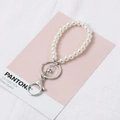 White glass pearl keychain with silver lobster clasp on rose quartz background - 8-Loop Silver Keychain