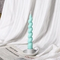 Spiral tapered soy wax candle in mint green finish on a white ceramic holder - Style A Light Green
