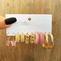 Close-up of pink butterfly pearl earrings set with gold chains held against wood desk - Gold (54780)