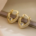 Luxury 18K gold-plated heart hoop earrings with sparkling cubic zirconia on beige fabric - Hollow Heart with Heart Center Stone (44208) / Gold