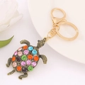 Detailed view of turtle keychain with colorful rhinestones on a white plate - Turtle 18 (Bronze Multi-color)