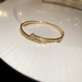 Macro shot of 18k gold plated bangle with LOVE lettering and heart-shaped zircon stones - 24# Golden Heart Letter LOVE