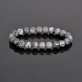Natural map stone beaded bracelet with 8mm grey veined jasper beads on reflective surface - Map Stone