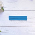 Royal blue high elasticity sports headband with soft knit texture on white wood background - Lake Blue