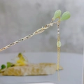 Close-up of vintage golden hair pin with emerald green buds and pearl tassel details - F0741-Green Flower Bud