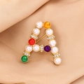 Golden letter A brooch with pearls and colorful beads on a beige fabric background - Gold Letter A Pearl Rhinestone (XD11181)