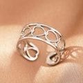 Macro shot of silver-colored stainless steel ring with continuous heart cutouts - Silver Hearts (C1486)