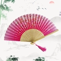 Pink cherry blossom folding fan with bamboo carving and elegant pink tassel - Cherry Blossom Rain - Carmine