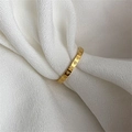Minimalist 18k gold plated titanium heart engraved ring on soft white fabric background - Full Circle Heart Gold