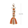 Handmade orange macrame daisy keychain with tassels and gold lobster clasp, 15cm length - Orange White Brown