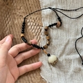 Ethnic beaded necklace with black beads, brown wooden cylinders and a white round pendant - Black Brown Pinecone