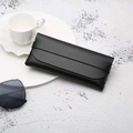 Minimalist black PVC leather sunglasses pouch with strap closure on a stone texture - Black