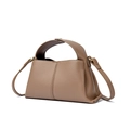Macro detail of brown leather texture and metal snap button on a square handbag - Khaki
