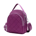 Purple quilted nylon mini bag with crossbody strap and gold zippers on white background - Purple