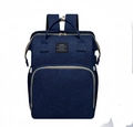 Detail of navy blue waterproof fabric diaper bag with front zipper pocket and logo patch - Blue Lace Trim