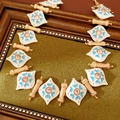 Detail of vintage enamel diamond pendant with blue heart and pink gemstone on green fabric - Necklace (Gold-Blue)