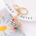 Macro detail of heart crystal keychain with multicolored gemstones and gold lobster clasp - Colorful Rhinestone Flower Heart
