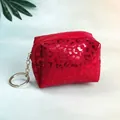 Detail of red leopard print coin purse with zipper and metallic silver keychain hook - Red
