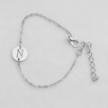 Silver chain bracelet featuring a circular pendant with an engraved letter N and lobster clasp - Silver N