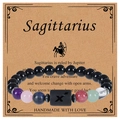 Detail of Sagittarius zodiac bracelet with black obsidian beads on a vintage gift card - Sagittarius