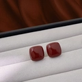 Elegant square wine red stud earrings with glossy finish on a grey velvet jewelry box - 12mm / 12mm Ancora Red