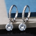 Silver pear-shaped drop earrings with round cubic zirconia on textured stone background - E719 Round / Silver
