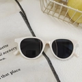 Retro cream white cat-eye sunglasses with dark grey lenses on a linen fabric background - Rice White 16 - Rounded Simple Retro