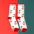 Christmas socks in white with red stripes and cartoon pudding patterns on a festive backdrop - Bell