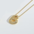 Macro shot of gold-plated chunky initial B pendant necklace with pave diamond setting - Letter B