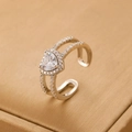 Macro detail of heart-shaped zircon ring with micro-pave stones and open silver band - Silver Heart Zirconia Open Ring (6916)