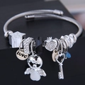 Adjustable stainless steel beaded bracelet with angel, heart, and key charms in silver tone - White