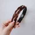 Brown braided headband with silver rhinestone accents shown in hand against white wall - Four-strand Double Row Rhinestone (2.5CM Wide) / Tan